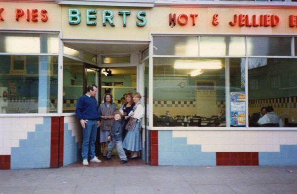 Old Kent Road, c1980. Berts Pie and Mash shop showing the owner Shirley Austin and staff in the doorway.  X.png