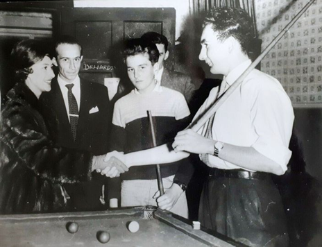 Eugenia Road, Bermondsey 1959, Billiards room 4Y's Club. Princess Margaret, club leader Sydney Jones (With the cue on his shoulder) and 17-year-old club member John Regan next to him.  X.png