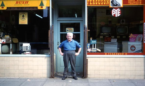 Spa Road, c1970. Mr Hickey outside his shop.  X..png