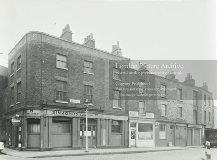 Redcross Way, Park Street left c1956, showing Simmonds Barfitters Ltd at number 19, with a cafe and a row of shops beyond.  Pic 1.  X..png