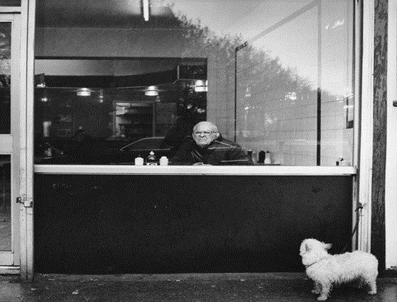 Southwark Park Road,1992, Lou Farrow's eel and pie house.  A dog is left outside while his owner tucks into his pie and mash.  X..png