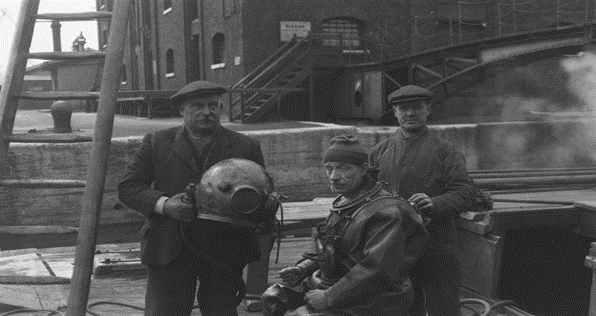 Surrey Docks, Diver Alfred Yates being prepared to go down for under-water repairs, c1930. X..png