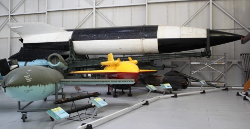 1.  A V1 bomb in the foreground (green) and a V2 bomb in the background (black and white).  RAF Museum at Cosworth.   X..png