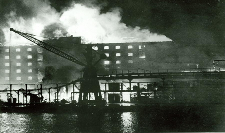 Surrey Commercial Docks. 1940, showing the fire damage caused by Germany bombing during a night-time raid.  X..png