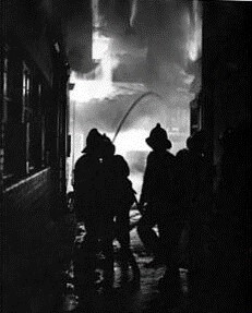Victory Place, SE17, Southwark, 27 April 1958.  Firefighters in action with hosepipes during a fire at a warehouse.  X.  .jpg