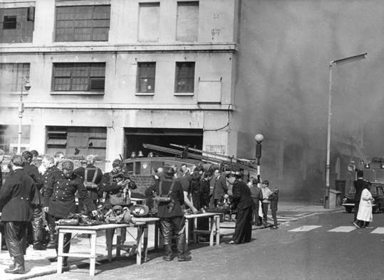 Stamford Street, Southwark, Firefighters, and onlookers outside Lyons Maid Ltd, 1968.  X..png