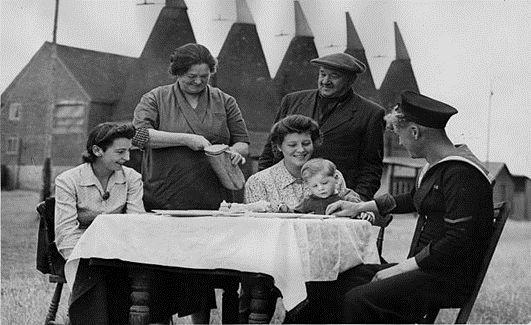 Beltring, Paddock Wood, Hop-Picking 1944. M Clark prepares lunch for a hop picking family from Bermondsey.  X..png