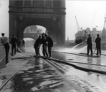 Tower Bridge jams when the metal expands in the summer heat in 1968, firefighters cool it down with their hose.  1  X..jpg