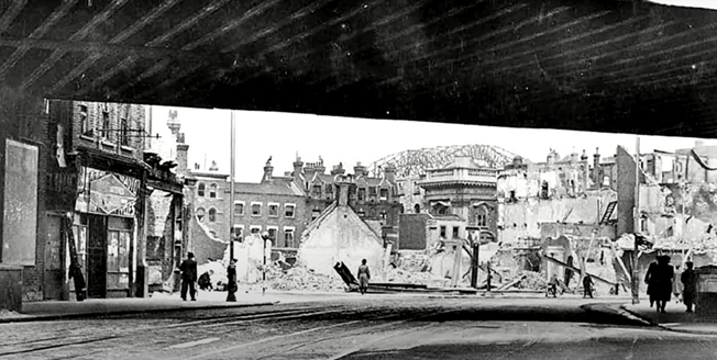 Elephant & Castle, looking under Walworth Road bridge towards bomb damage 1941. Opposite is where the Heygate Estate would eventually go, with Elephant Road under bridge left. X..png