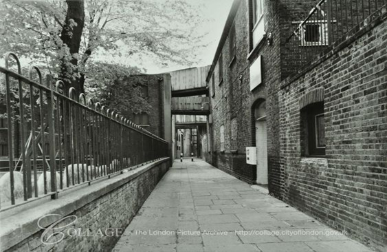 Rotherhithe Street, Rotherhithe, looking west by St Mary's Church, showing bridges between granaries.  X..png
