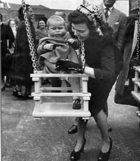 Druid Street 1951, Arnold Estate Playground, actress Simone Silva helps a child into a swing after the opening.  1 X..png