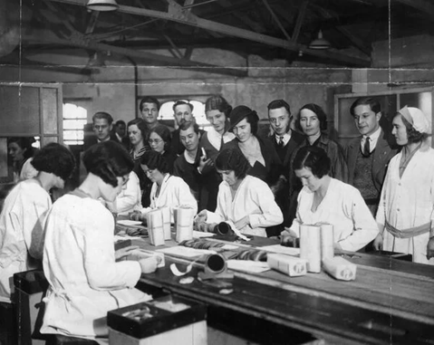 Peek, Frean & Co Limited, Bermondsey, Girls Packing Biscuits watched by Swiss students who are on an educational tour of the UK, c1933.   X..png