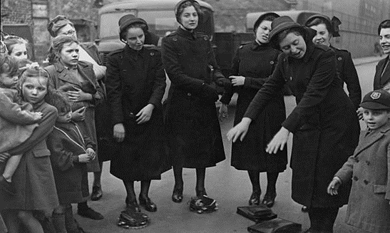 East Street Market, 1950. Female Salvation Army cadets singing songs with actions, with a group of children.   X..png