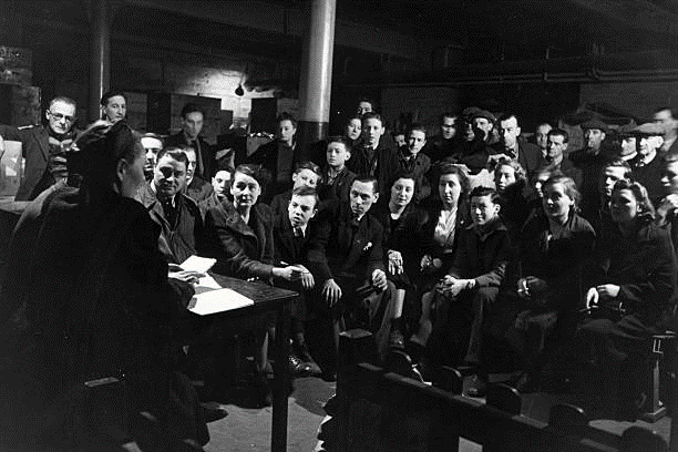 Bermondsey, A discussion circle meets in an air raid shelter during the Blitz, 1941.  X..png