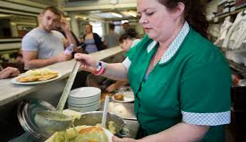 TOWER BRIDGE ROAD, KELLY SERVES CUSTOMERS WITH PIE AND MASH AT MANZE’S PIE AND MASH SHOP. X..png