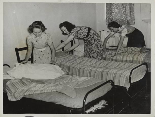 4 Making up their beds at Matfield Court Brenchley Kent. Left to right. Miss E. Evenden. Miss E. Seager & Miss G. Pavey,1941.  X..png