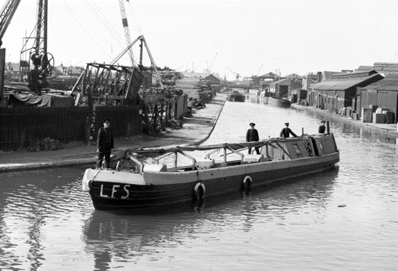 Grand Surrey Canal, London Fire Brigade boat during WWII, about to turn and pass underneath Evelyn Street, Blackhorse Bridge,towards Old Kent Road.  X..png