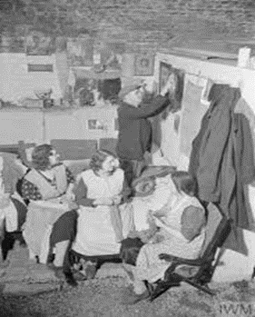 WW2, The Blitz. Passing the time in a Railway Arch Bomb Shelter. Knitting and decorating could help. X..png