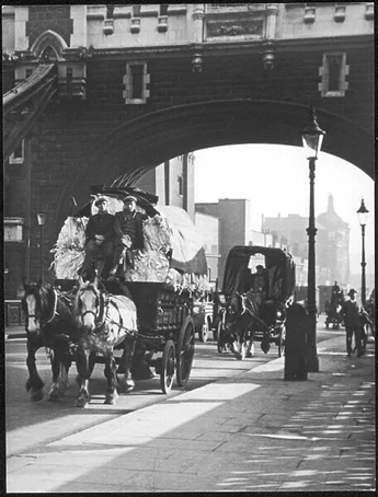 Tower Bridge, a rag and bone horse and cart and other horse drawn vehicles.  X..png