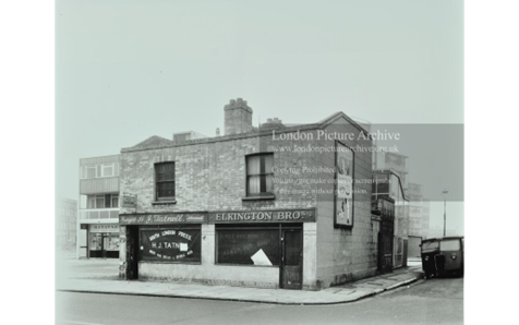 New Church Road, Southwark, Edmund Street right. H. J. Tatnell newsagents and tobacconists; Elkington Brothers Family Butchers.  1957.  X..png
