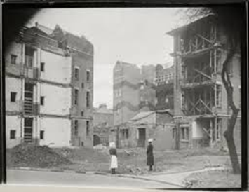 Havil Street, St Giles Hospital, Camberwell,1943. The Matron inspecting bomb damage.  X..png