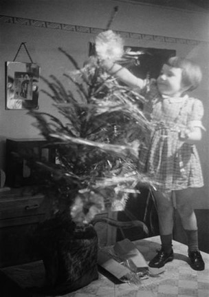 Christmas Street, a little girl decorates a Christmas tree, December 1946.  X..jpg