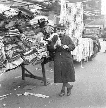 Bermondsey Square Market 1954, Bernard Goodman (10) helps his father on his days off from school.  X..png