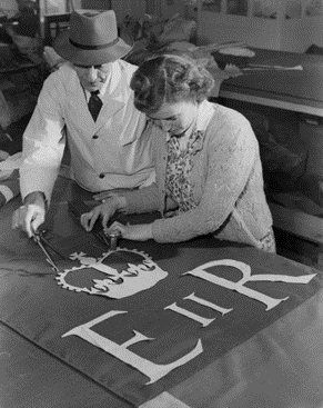 Old Kent Road 1952. Flag makers Sam Ward and Joyce Griggs, John Edgington & Co flag factory.   X..png