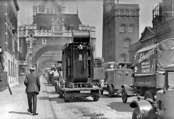 Tower Bridge, a transformer being transported across the bridge c1920.   X..png