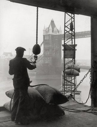 Pool of London Dockworker handling a cargo of bagged nuts 1947.jpg