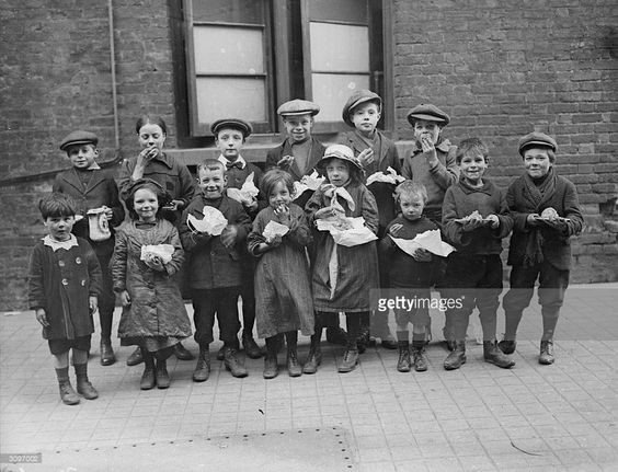 Children eating a penny's worth of Plum Duff from soup kitchens in Bermondsey….jpg