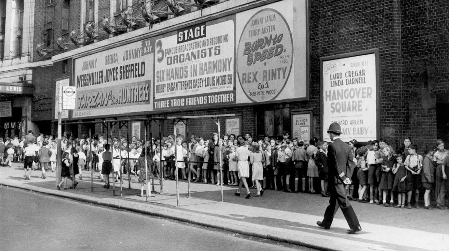 A long queue of children waiting outside the popular Trocadero in the 1940s.jpg