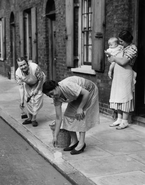 1939 Housewives of Roupell Street, London, painting kerbs white to help night time traffic during WW II, near Waterloo X.jpg