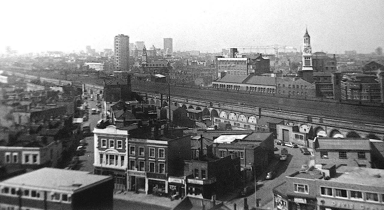 The Blue, Southwark Park Road in foreground, white building the Blue Anchor Pub, corner of Blue Anchor Lane (left) Bombay Street to the right. Peak Freans Biscuit Factory in background..jpg