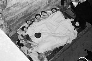 O'Rourke family of St James's Road, Bermondsey, sleep under a blanket in an air raid shelter under the railway arches, probably at Dockley Road, Bermondsey in November 1940  X.jpg