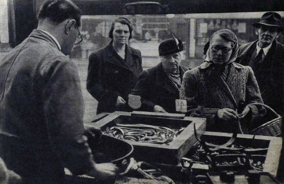 An eel stall at Elephant and Castle. Hot, a shilling a basin, jellied, two shillings. 1949   X.jpg