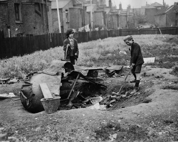 Two young boys playing golf on a makeshift course off the Old Kent Road.jpg