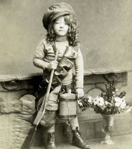 THE FEY FAMILY The picture was, taken at EC Watling studio, based at 33 Jamaica Road, in Bermondsey, the young girl appears to be wearing her father’s trench cap and kit, a leather bandolier.jpg