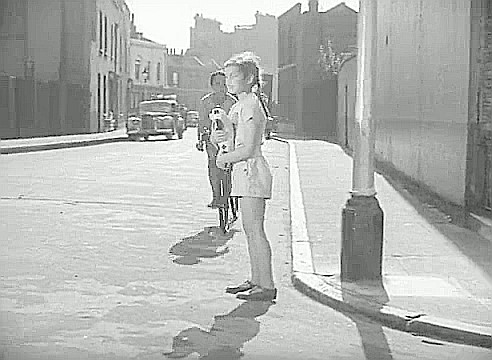 Film Adventure in the Hopfields 1954, this is looking along Ralph Street. The building with the white first floor frontage, seen behind the car, was the Duchess of Kent Pub 67 Deverell Street..jpg