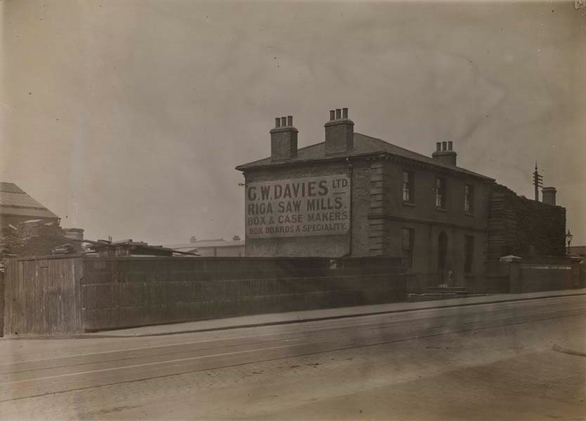 Surrey Canal,G.W. Davies Ltd., box and case makers, on Blackhorse Bridge, Piles of their timber can seen above the property walls..jpg