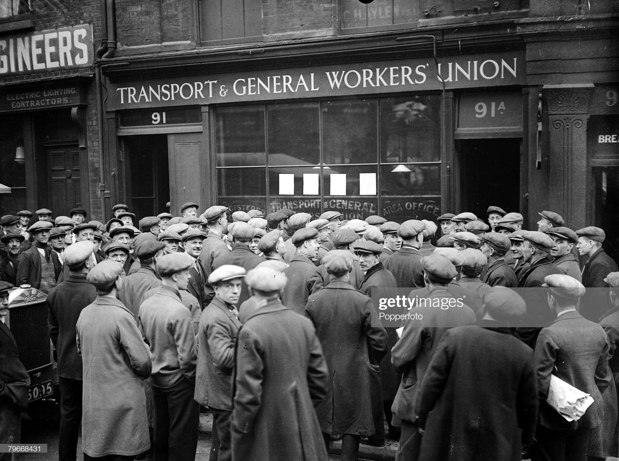 Tooley Street 1930, Striking shipyard workers gather outside the Transport & General Workers Union office during the dock strike. x.jpg