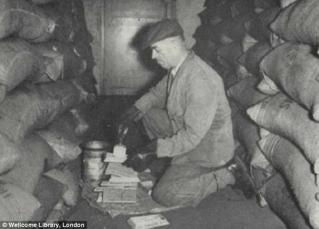 Another worker prepares deadly bait for the rats on what is described as a Bermondsey 'rat run’ 1957.  X.png