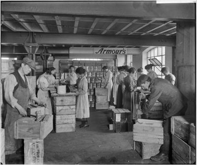 Tooley Street 1919, Armour and Company, men and women at work packing and labelling crates in the warehouse.  X.png