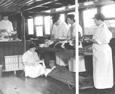 River Emergency Service 1939-41.A Doctor gives the 'patient' an injection,the nurses and crew are giving a demonstration of the ship and its operating theatre and other facilities for dealing with casualties.jpg