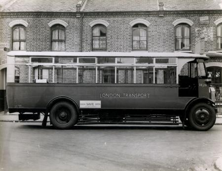 View of single deck DE-type bus, no DE28, 1934. parked near  the Old Kent Road Gararge.   X.png
