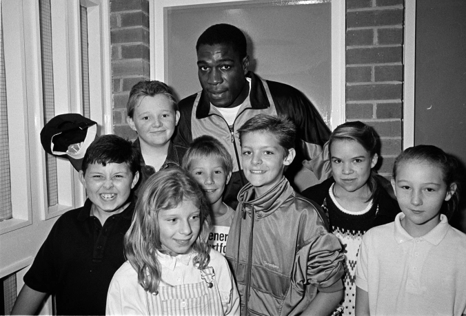 Southwark Park Athletics 1989.Frank Bruno poses with some young athletes at Southwark Park.  X.png