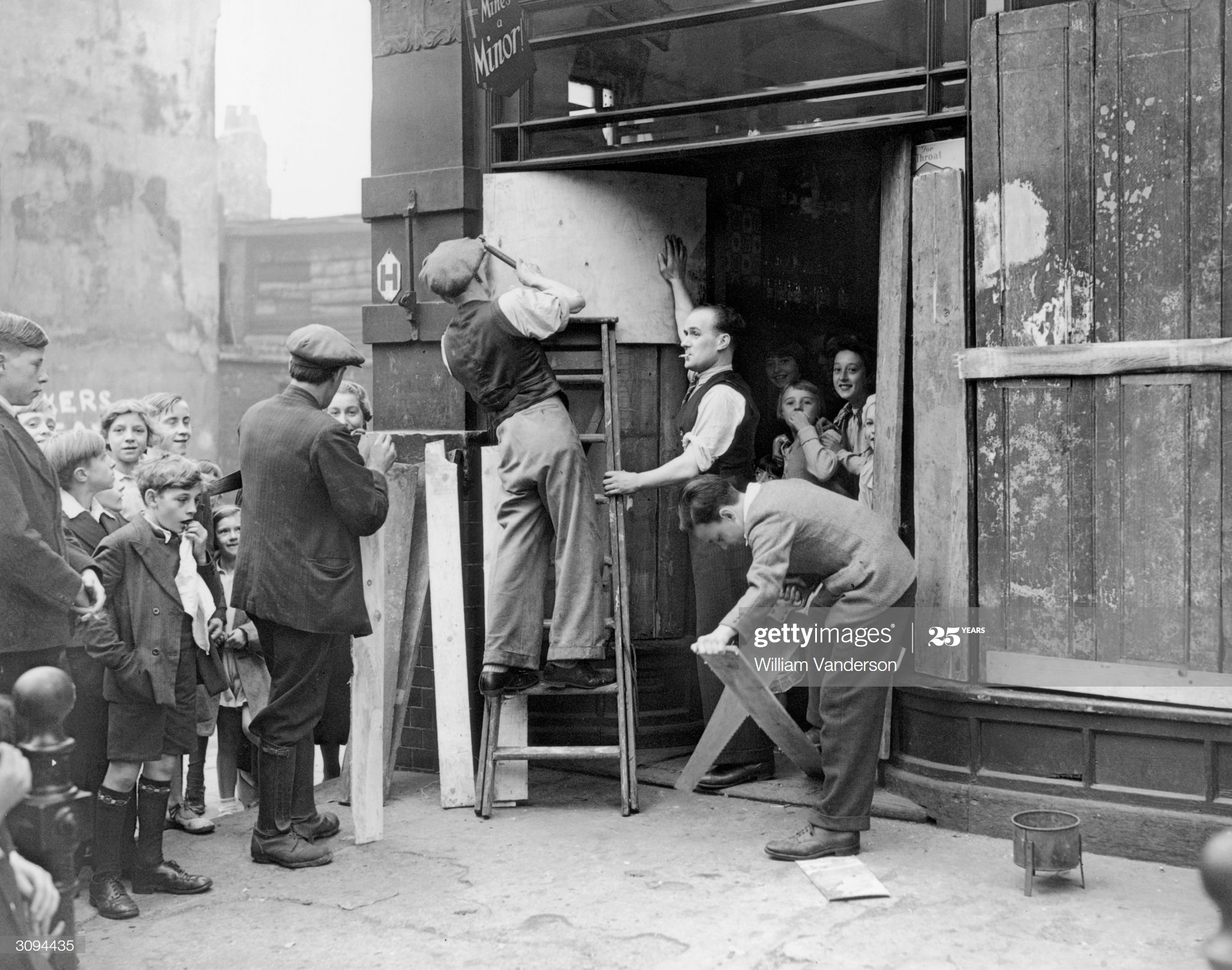 Long Lane Bermondsey 1937, Men boarding up the window of a shop before a Fascist march led by Sir Oswald Mosley, Leader of the British Union of Fascists, passes by.  X.png