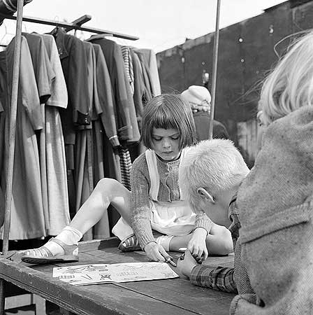 Bermondsey Antiques Market 1959-1965,children sitting on a table colouring.   X.png