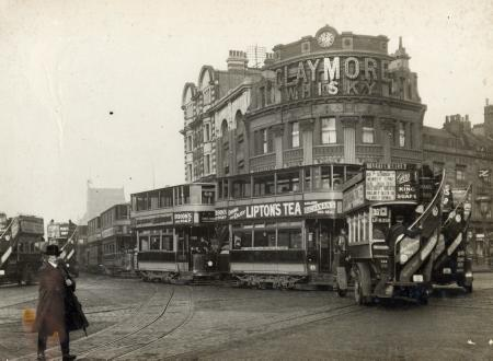 Elephant and Castle, street scene featuring a line of electric trams and motor buses 1920.png