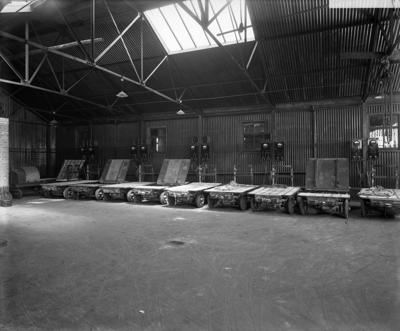 Surrey Commercial Docks, Rotherhithe c1920. Electric motorised goods trolleys charging in the electric garage.   X.png